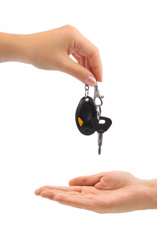 Hands and car key isolated on white background
